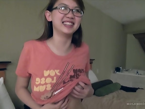 Sensational Asian girl with Glasses plays with her titties before fingering herself.